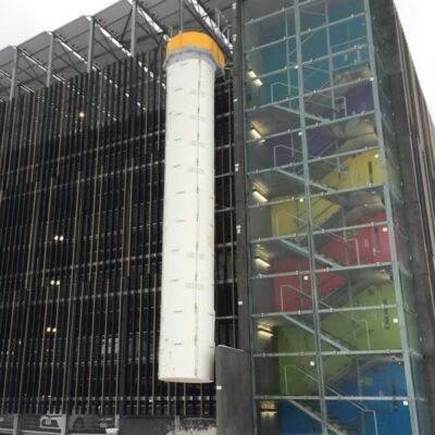 A Superchute snow chute installed on a parking garage.